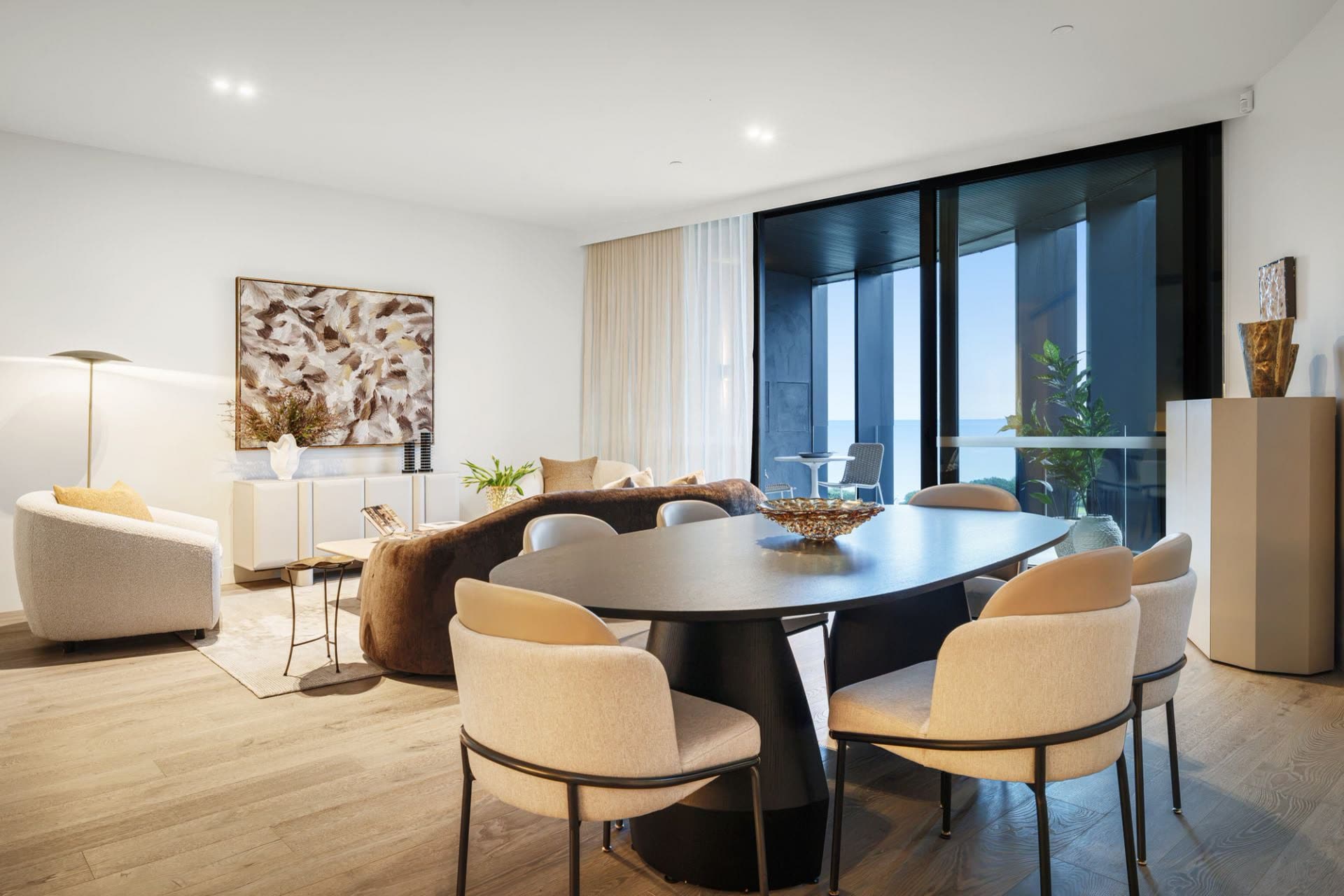 Dining room with a dark oval table and bay light